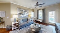 Located at 1600 Marina Rd in Irmo, SC, this thoughtfully designed 2-bedroom, 3-bathroom residence offers a comfortable and stylish single-floor layout. The open-concept kitchen and living area serves as the heart of the home, featuring rich dark wood cabinetry, stainless steel appliances including a full-size refrigerator, dishwasher, and range, plus a granite-topped breakfast bar with seating. Crown molding and warm hardwood flooring add a refined touch to the living room, which is bathed in natural light through large windows with views of the surrounding area and benefits from a ceiling fan overhead. Both bedrooms are carpeted and generously sized, each with ceiling fans, large windows that invite ample natural light, and outdoor views. The primary bedroom connects to a well-appointed en-suite bathroom featuring dark wood vanity cabinetry, a wide mirror, and direct access to a spacious walk-in closet with built-in shelving. A second full bathroom mirrors this quality with tile flooring and a refined vanity. Two closets provide additional storage throughout. The hallway connects all spaces efficiently, contributing to a cohesive and functional floor plan ideal for comfortable everyday living.