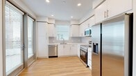 Located at 14817 Foothill Blvd in Fontana, CA, this well-designed single-floor residence offers three bedrooms, two bathrooms, and a thoughtful layout that maximizes functionality. Light wood flooring flows seamlessly throughout, lending warmth and visual continuity to every room.

The modern kitchen is a standout feature, showcasing bright white cabinetry extending to the ceiling, a subway tile backsplash, stainless steel appliances including a refrigerator, range, microwave, and dishwasher, and a window that draws in natural light. Large sliding glass doors connect the kitchen and living area directly to a private balcony, enhancing the sense of openness.

The hallways are clean and well-lit with recessed lighting, guiding residents to three comfortable bedrooms, each finished with the same light wood flooring and fitted with windows dressed in horizontal blinds for privacy and light control. The spacious primary bedroom offers ample room for furnishings.

Both bathrooms are finished in a crisp, all-white palette with wood-look flooring, white vanity cabinetry, backlit mirrors, built-in shelving, and bathtub-shower combinations. A dedicated laundry area and five closets provide generous storage throughout. The overall aesthetic is clean, contemporary, and move-in ready.