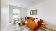 Located at 1016 NW 67th St in Oklahoma City, this thoughtfully designed one-bedroom, one-bathroom unit offers a clean, modern aesthetic across a single level. The open-concept living and kitchen area is bright and airy, anchored by large floor-to-ceiling windows that flood the space with natural light and provide views of the surrounding neighborhood. Light hardwood flooring runs throughout, complementing the crisp white walls and contemporary finishes. The kitchen is well-appointed with warm wood-grain cabinetry, white quartz countertops, a tiled backsplash, stainless steel appliances including a full-size refrigerator, range, microwave, and dishwasher, and open shelving for added storage and display. The bedroom is a comfortable retreat featuring a ceiling fan, a large window with outdoor views, and hardwood flooring. The bathroom connects to the bedroom via a hallway and includes large-format tile flooring, a walk-in shower with glass enclosure, and a wood-toned vanity. A dedicated laundry area with a stacked washer and dryer and built-in shelving adds everyday convenience. The unit combines functional efficiency with a modern, minimalist design sensibility throughout.