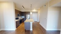 Located on Outlet Blvd in Fort Worth, TX, this single-story residence offers a well-designed layout that balances functionality with modern finishes. The kitchen serves as the centerpiece of the main living area, featuring dark espresso cabinetry extending to the ceiling, a subway tile backsplash, and a full suite of stainless steel appliances including a refrigerator, range, and microwave. A large kitchen island with a granite countertop and built-in sink anchors the space, illuminated by pendant lighting overhead. Track lighting and recessed fixtures provide additional brightness throughout.

The living area extends naturally from the kitchen, finished with rich hardwood-style flooring, a ceiling fan, and access to an exterior door. Natural light filters in through blinded windows, enhancing the open, airy atmosphere.

Bedrooms are carpeted for comfort, each featuring a ceiling fan with light fixture and a window with outdoor views. The neutral tones create a calm, restful environment throughout.

The bathrooms are finished with large-format tile flooring, dark wood vanities topped with granite counters, wide framed mirrors, and a tub-shower combination with white subway tile surround. Clean lines and recessed lighting contribute to a polished, contemporary aesthetic throughout the entire residence.