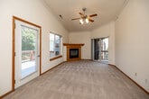 This single-floor, 3-bedroom, 2-bathroom home offers a thoughtfully designed layout that balances comfort and functionality. The living room serves as the heart of the space, featuring vaulted ceilings, a ceiling fan, a wood-trimmed fireplace, and a glass door leading to an outdoor balcony. Natural light fills the room through a large adjacent window, creating a bright and welcoming atmosphere. Warm hardwood flooring transitions into plush carpet in the living and bedroom areas, adding a cozy feel throughout.

The kitchen is efficiently arranged with ample honey-toned wood cabinetry, a double stainless steel sink, white appliances including a refrigerator and dishwasher, and durable hardwood flooring. Crown molding adds a refined touch to the space.

The primary bedroom is generously sized and features vaulted ceilings, a ceiling fan, plush carpeting, and sliding glass door access to a private balcony with outdoor views. It is complemented by a spacious walk-in closet with wire shelving for organized storage. The secondary bedrooms offer carpet flooring and windows with garden views.

Both bathrooms are finished with tile flooring and warm wood vanities. The full bathroom includes a double-sink vanity and a tub/shower combination. A hallway and dedicated closet complete the practical floor plan of this well-maintained home.