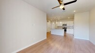 Located in San Antonio, TX (78253), this single-story, 3-bedroom, 1-bathroom home offers a thoughtfully designed open-concept layout. Light wood-style flooring runs throughout the main living areas, complemented by neutral-toned walls and ceiling fans in each room, creating a clean and cohesive aesthetic.

The combined kitchen, dining, and living area forms the heart of the home. The modern kitchen is a standout feature, showcasing white shaker-style cabinetry, a granite countertop island with a built-in sink, stainless steel appliances including a range, microwave, and refrigerator, and elegant pendant lighting overhead. A pantry provides additional storage convenience.

The living area flows naturally from the kitchen and includes French doors that open to a private patio, allowing for seamless indoor-outdoor living and ample natural light.

The three bedrooms are carpeted for comfort, each equipped with a ceiling fan and windows fitted with blinds that invite natural light while maintaining privacy. Four closets, including a walk-in with wire shelving, offer generous storage throughout.

The bathroom features a dual-sink granite vanity, a tiled tub-shower combination, and wood-style flooring, maintaining the home's consistent modern finish. A dedicated hallway connects all rooms efficiently.