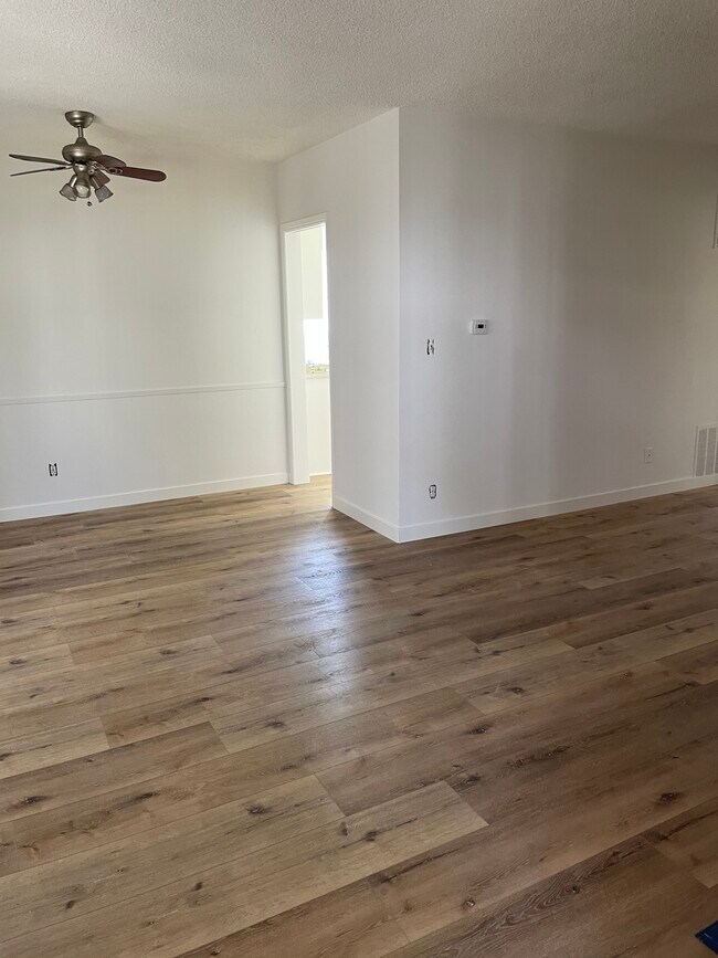 Living and dining room with waterproof flooring. - 12850 Oxnard St