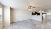 This 1280 square foot two-story home in Iowa, LA, offers a well-designed living space with 3 bedrooms and 3 bathrooms. The property is split between two floors, with 680 square feet on the ground floor and 600 square feet on the upper level. The primary bedroom, measuring 140 square feet, provides a comfortable retreat.

The home features a functional layout, including a combined kitchen and living room area, perfect for entertaining. The kitchen is equipped with dark wood cabinetry, white appliances, and ample counter space. Throughout the house, neutral-toned walls and carpeted floors create a blank canvas for personalization.

Large windows in the bedrooms allow for natural light, while ceiling fans offer air circulation. The bathrooms are designed with simplicity and practicality in mind, featuring pedestal sinks and standard fixtures. The property also includes a staircase connecting the two floors, a hallway for easy navigation, and a closet for additional storage.

The concrete flooring in some areas adds a modern touch and easy maintenance. Overall, this home at 1080 Vineyard Loop provides a practical and comfortable living space suitable for various lifestyles.
