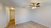 Located at 2317 Botanical Dr in Killeen, Texas, this single-story, 2-bedroom, 1-bathroom home offers a practical and well-organized layout. Throughout the home, light-toned luxury vinyl plank flooring provides a clean, cohesive look, complemented by neutral gray walls and crisp white trim and doors.

The living room serves as the central gathering space, featuring a ceiling fan with light fixture, a textured ceiling, a front entry door, and a window that invites natural light. A sliding glass door in the adjacent area further brightens the interior and provides outdoor access.

A central hallway connects the living areas to the bedrooms and bathroom, offering three closets for ample storage throughout the home. The primary bedroom is a comfortable size and includes a ceiling fan with light fixture and a textured ceiling. The second bedroom is similarly appointed with a ceiling fan and access to the hallway.

The bathroom is equipped with a full tub and shower combo featuring chrome fixtures and a clean white surround. The kitchen rounds out the floor plan, completing the home's functional layout.

Overall, the home presents a clean, move-in-ready aesthetic with consistent finishes and thoughtful use of space throughout its single floor.