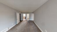 Located at 3938 Colchester Rd in Baltimore, Maryland, this single-floor home offers a straightforward and functional layout designed for comfortable everyday living. The interior is finished in soft, neutral gray tones throughout, creating a calm and cohesive atmosphere from room to room.

The living area is generously proportioned, featuring plush carpeting, baseboard heating, and windows that invite natural light while offering views of surrounding greenery. Panel-style doors and clean white trim add a classic touch to the space.

The bedrooms continue the carpeted flooring and neutral palette, with each room benefiting from natural light through sizable windows fitted with blinds. One bedroom includes a ceiling fan for added comfort, while another features a closet for convenient storage. Baseboard heaters are present throughout, ensuring reliable warmth.

The kitchen is well-appointed with light maple cabinetry, light granite-style countertops, a stainless steel sink, and a gas range, providing ample workspace and storage for daily cooking needs.

The bathroom is clean and practical, featuring a combination tub and shower, a toilet, and wood-look vinyl flooring, all finished in a light, neutral color scheme.

Overall, this home presents a tidy, move-in ready environment with consistent finishes and functional spaces suited for a variety of lifestyles.