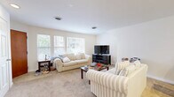 Located at 240 E University Ave in Cincinnati, OH, this generously sized 3-bedroom, 1-bathroom unit offers a comfortable and functional layout across a single floor. The open-concept living and kitchen area serves as the heart of the home, where warm-toned wood cabinetry, a full suite of appliances, and a peninsula counter with bar seating create a welcoming, social atmosphere. Track lighting illuminates the kitchen, while the adjoining living room benefits from multiple windows that invite natural light and offer views of the surrounding neighborhood. Soft carpeting flows throughout the living areas and bedrooms, adding warmth underfoot. The primary bedroom is exceptionally spacious, easily accommodating a full study or work-from-home setup alongside sleeping quarters, and features a closet with ample storage. The additional bedrooms are well-proportioned, each with their own windows providing natural light. The bathroom is clean and functional, featuring a white vanity with under-sink storage and a mirrored medicine cabinet. A standout feature of this unit is the private balcony, accessible from the living area, offering views of the tree-lined neighborhood and the surrounding Cincinnati cityscape — a pleasant outdoor retreat.