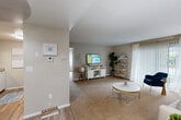 Located at 825 Pontiac Ave in Cranston, Rhode Island, this one-bedroom, two-bathroom residence offers a thoughtfully arranged single-floor layout designed for comfortable everyday living. The open living room features neutral-toned carpet, large sliding vertical blinds that invite natural light, and ample space for relaxing and entertaining. Adjacent to the living area, the dining room features light wood-style flooring, a closet for additional storage, and a ceiling light fixture, creating a welcoming space for meals. The kitchen is equipped with warm wood cabinetry, granite-look countertops, a gas range, and matching appliances, all set atop easy-care hardwood-style flooring. The generously sized primary bedroom offers plush carpeting, large windows with sheer curtains, baseboard heating, and a dedicated closet with a full-width hanging rod. Two full bathrooms serve the unit, one of which includes a shower-tub combination. A second closet provides further storage convenience. Throughout the residence, a soft, neutral color palette, consistent flooring transitions, and clean lines contribute to a calm and cohesive ambiance well-suited for comfortable single-floor living in the Cranston community.