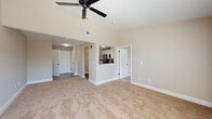 Located at 127 Andorra Glen Ct in Lafayette Hill, PA, this one-bedroom, one-bathroom residence offers a well-designed single-floor layout. The kitchen is a standout feature, showcasing white shaker cabinetry, granite countertops with a matte black faucet, a classic subway tile backsplash, and a full suite of stainless steel appliances including a gas range, over-the-range microwave, and dishwasher. A pass-through window connects the kitchen to the living area, enhancing the open feel between the two spaces. The living room is finished with plush wall-to-wall carpeting, crown molding, and neutral warm-toned walls that create a clean, inviting atmosphere. The generously sized bedroom features large windows with blinds that bring in natural light and offer views of the surrounding neighborhood, along with crown molding and soft carpeting. A dedicated closet with built-in storage provides convenient organization. The hallway connects all areas efficiently and includes access to a dedicated closet. The bathroom is finished with wood-look luxury vinyl flooring, a tub/shower combination, and sleek matte black hardware and towel bars, providing a modern, cohesive aesthetic throughout.