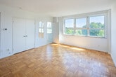 Located on the 7th floor at 291 Avenue Rd in Toronto's prestigious Avenue Road corridor, this one-bedroom, one-bathroom unit offers a compact and efficiently laid out living space across a single floor. The unit includes a bedroom, bathroom, kitchen, and hallway.

The bedroom is the largest room in the unit, benefiting from large windows that frame lush treetop views and allow abundant natural light to fill the space. Classic parquet wood flooring in a herringbone-style pattern runs throughout, adding warmth and character to the bright, white-walled interior. A set of double closet doors provides practical built-in storage.

The kitchen is neatly appointed with white cabinetry above and below the counter, a white tile backsplash, a stainless steel sink, and a full-size refrigerator — offering all essential amenities in a well-organized layout.

The bathroom features a full bathtub and shower combination, finished with white wall tiles accented by a classic dark border detail along the upper edge, lending a clean, traditional aesthetic.

The unit's crisp white walls, consistent parquet flooring, and sun-filled windows create a bright and airy atmosphere throughout. Its location in the sought-after Deer Park neighbourhood places it near top amenities, parks, and transit.