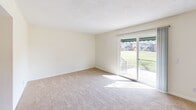 Located at 901 Rob Roy Ct in West Columbia, SC, this two-story home offers three bedrooms, two bathrooms, and a practical layout spread across two well-proportioned floors. The main level features a carpeted living room filled with natural light from a sliding glass door that opens to an outdoor patio with pleasant neighborhood views. The adjacent kitchen is equipped with warm wood cabinetry, light countertops, a double stainless steel sink, hardwood-style flooring, and ample upper and lower cabinet storage. A separate dining room with a classic chandelier and a nearby hallway connect the main living areas seamlessly. The upper level hosts all three bedrooms, each finished with plush neutral carpet and ceiling-mounted light fixtures. The spacious primary bedroom features a ceiling fan with light kit and large windows that invite natural light and outdoor views. Additional bedrooms offer quiet, well-lit spaces with their own lighting. The two bathrooms are clean and functional — one features a wood vanity with a marble-style countertop, a large mirror, hardwood-style flooring, and multi-bulb vanity lighting, while the other includes a full tub and shower combo with built-in shelving. Hallways connect all upper-level rooms efficiently, completing this well-organized home.