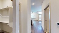 This thoughtfully designed studio offers a bright, open-concept layout that maximizes every square foot. Rich hardwood-style flooring flows seamlessly throughout the main living area, creating a warm and cohesive aesthetic. Large windows and a full-light entry door with transom window flood the space with natural light, while a ceiling fan adds comfort and functionality to the living area.

The kitchen serves as a focal point of the unit, showcasing granite countertops that extend into a peninsula with an undermount sink — ideal for both meal prep and casual dining. Gray shaker-style cabinetry reaches to the ceiling, offering generous storage, and is complemented by a classic subway tile backsplash. Stainless steel appliances, including a refrigerator, range, and microwave, complete the polished look. Geometric pendant lights add a stylish, modern touch overhead.

A double-door closet provides ample storage within the living space. The bathroom is finished with marble-look tile flooring, a granite-topped vanity with gray cabinetry, a framed mirror, and a shower/tub combination — delivering a clean, upscale feel. The entry hallway also includes an additional storage closet. Crisp white walls and recessed lighting throughout give the unit a fresh, contemporary ambiance.