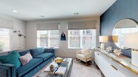 Located at 12 W Gay St in the heart of downtown Columbus, Ohio, this single-floor residence offers a well-designed, modern living experience. The open-concept layout seamlessly connects the kitchen and living area, creating an inviting and functional space. The kitchen is outfitted with warm walnut-toned cabinetry, stainless steel appliances including a range, microwave, dishwasher, and French door refrigerator, along with white quartz countertops, a tile backsplash, and open shelving for display storage. Light wood-style flooring runs throughout the kitchen and main living areas. The living room is bright and welcoming, featuring multiple windows with Roman shades and horizontal blinds that allow ample natural light to filter in. Two bedrooms are carpeted for comfort and each receives natural light through large windows with views of the surrounding neighborhood. The primary bedroom includes walk-in closet access. Both bathrooms are finished with wood-toned vanity cabinetry, white quartz countertops, and wood-look tile flooring. One bathroom features a bold black-and-white plaid accent wall with a tub and shower combination, while the second offers a clean, neutral aesthetic with a soaking tub and shower. The overall ambiance is contemporary and polished throughout.
