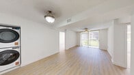 Located at 12375 SW 18th St in Miami, FL, this well-appointed 2-bedroom, 2-bathroom residence offers a clean, modern aesthetic throughout its single-floor layout. Light wood laminate flooring flows seamlessly across the living room, bedrooms, and hallways, creating a warm and cohesive feel. The spacious living room is a standout feature, filled with natural light streaming through a large sliding glass door that opens to an outdoor area with green views, complemented by a ceiling fan overhead. The kitchen is thoughtfully updated with light flat-panel cabinetry, stone countertops, a subway-tile backsplash, and white GE appliances including a range, microwave, and dishwasher. Both bedrooms are generously sized, bright, and airy, each featuring windows that frame pleasant outdoor greenery. The primary bedroom includes a dedicated closet with built-in storage. Both bathrooms have been renovated with white tile, stone-topped vanities, and sleek sliding glass enclosures — one featuring a tub-shower combination and the other a walk-in shower with warm mosaic tile flooring. Textured ceilings and crisp white walls throughout lend the space a clean, move-in-ready character well-suited to Miami living.