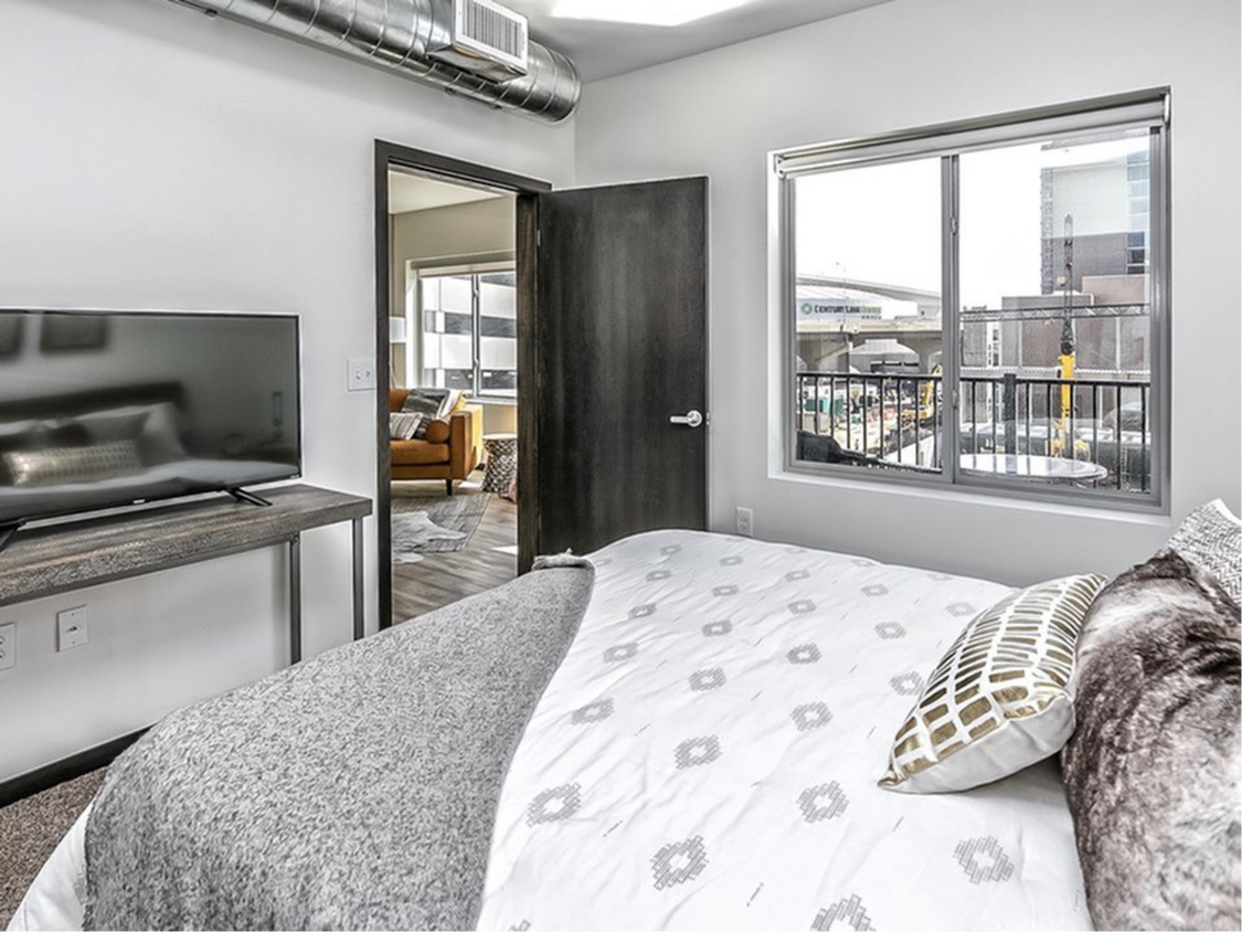 Spacious Bedroom w/ Large Window - The Capitol District Apartments