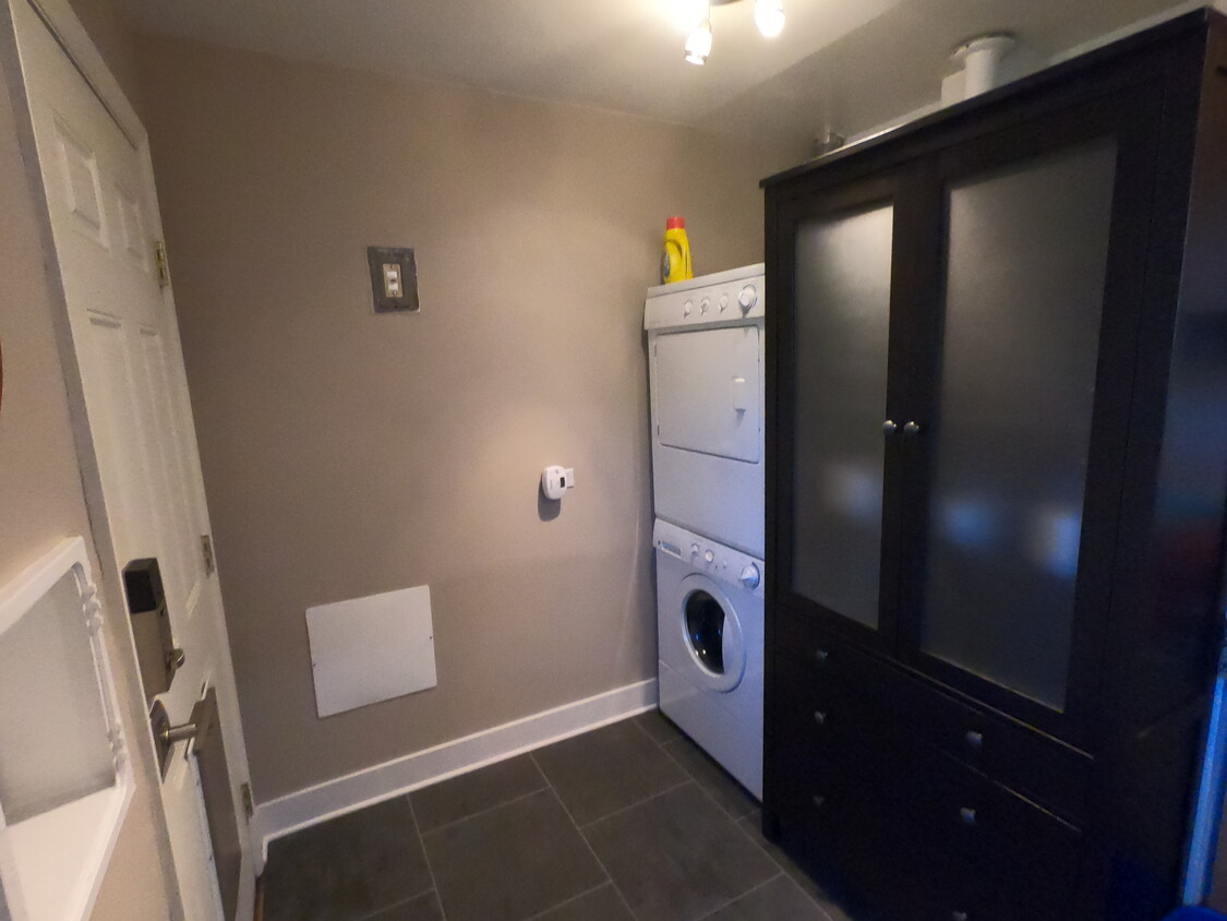 Stacked washer and dryer. Back door leads to private backyard and alley-access garage. - 4716 W 36th Ave