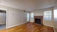Located at 4470 S Lemay Ave in Fort Collins, CO, this well-appointed one-bedroom, one-bathroom unit offers a practical and comfortable single-floor layout. The living room serves as the focal point of the home, highlighted by a classic brick wood-burning fireplace flanked by windows that invite natural light. Warm hardwood flooring runs throughout the main living areas, complemented by a textured ceiling and neutral-toned walls. The kitchen is outfitted with rich wood cabinetry, granite-style countertops, a stainless steel refrigerator, range, and microwave, providing a functional and attractive cooking space. A dedicated dining area adjacent to the kitchen adds versatility. The bedroom offers a comfortable retreat with plush carpeting, a generous closet, and a window with outdoor views. The bathroom features hardwood flooring, a full soaking tub, a vanity with dark granite countertops, warm wood cabinetry, and a large mirror. The unit includes direct exterior door access from both the living area and kitchen, adding convenience. Throughout the space, a consistent neutral color palette and clean finishes create a cohesive and move-in-ready atmosphere.