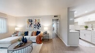 This single-story, 2-bedroom, 2-bathroom home offers a thoughtfully designed layout that maximizes both comfort and functionality. The living room serves as the heart of the home, featuring light wood-tone flooring, neutral walls, and a large window with vertical blinds that invites natural light into the space. The open sightlines connect seamlessly to the hallway leading to the private quarters.

The kitchen is a standout feature, showcasing crisp white shaker cabinetry, light countertops, stainless steel appliances including a dishwasher, recessed lighting, and light wood-tone flooring that extends throughout. An adjacent open shelving area adds practical storage.

The primary bedroom is a comfortable retreat with plush carpeting and ample natural light, while the second bedroom and dedicated office space — complete with a built-in desk and large window overlooking the outdoors — provide versatile living arrangements. Both bathrooms are finished in clean, classic white, with one featuring a full soaking tub and shower combo with white cabinetry vanity. Carpeted bedrooms and office areas add warmth, while the in-unit laundry room adds everyday convenience. The overall ambiance is bright, clean, and move-in ready.