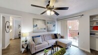 Located at 10730 Glenora Dr in Houston, TX, this single-story, one-bedroom, one-bathroom home offers a thoughtfully arranged floor plan that maximizes every inch of its compact footprint. Wood-style flooring flows throughout, complementing the neutral color palette and creating a cohesive, modern aesthetic.

The living room is a bright and welcoming space, featuring a ceiling fan with light fixture and a sliding glass door that opens to a private outdoor patio, allowing natural light to fill the room. Built-in shelving adds both functionality and character to the area.

Adjacent to the living room, the dining area accommodates a full-sized dining table and benefits from a window that brings in additional natural light. The kitchen is equipped with white cabinetry, a light stone-finish peninsula countertop, stainless steel appliances including a microwave and range hood, a black refrigerator, and track lighting overhead. A dedicated laundry area is conveniently accessible from the kitchen.

The generously sized primary bedroom includes a ceiling fan, a natural light-providing window, and direct access to the bathroom. A walk-in closet offers ample storage. The bathroom features wood-style flooring and a shower/tub combination, completing this well-appointed home.