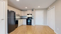 Located at 350 Bobolink Ridge in Ottawa's Barrhaven neighbourhood, this single-floor, 3-bedroom, 2-bathroom unit offers a practical and well-appointed layout. Throughout the space, light wood-style laminate flooring creates a cohesive and contemporary feel, complemented by neutral warm-beige walls and clean white trim.

The kitchen is efficiently designed with ample white cabinetry, dark granite-style countertops, and a full suite of black appliances including a refrigerator, electric range, dishwasher, and under-cabinet range hood. The living room is bright and open, featuring a wall-mounted ductless air conditioning unit, a baseboard heating system, and access to a private balcony through a glass door, allowing natural light to fill the space.

Each of the three bedrooms is well-proportioned with large windows fitted with horizontal blinds, offering views of the surrounding residential neighbourhood. The primary bedroom includes a built-in double closet with bi-fold doors. Both bathrooms are finished consistently, featuring full tub-shower combinations, toilets, and the same wood-style flooring found throughout the unit. The overall layout is functional and efficient, offering comfortable living within a modern residential community.