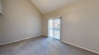 This 960 square foot townhouse in Wichita, KS offers a functional two-floor layout. The ground level, spanning 550 sq ft, includes an open-concept living area and kitchen. The kitchen features wood cabinetry, white appliances, and a practical L-shaped design. A partial wall with columns separates the kitchen from the carpeted living space, maintaining an open feel while defining distinct areas.

The upper level, covering 410 sq ft, houses the 130 sq ft primary bedroom, bathroom, and additional living space. The bedroom boasts a large window and a closet. The bathroom includes a vanity with a granite-like countertop and a shower/tub combination. Carpeting continues throughout the upper level, with the exception of wood-look flooring in the bathroom.

Notable features include high ceilings in parts of the upper level, enhancing the sense of space. Multiple windows throughout provide natural light, while ceiling-mounted light fixtures offer additional illumination. The neutral color palette, primarily in beige and white tones, creates a versatile canvas for personalization. This townhouse combines efficiency and comfort in its compact yet well-designed layout.