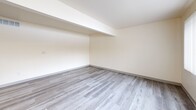Located at 4568 Blackstone Trl in Okemos, Michigan, this one-bedroom, one-bathroom unit offers a thoughtfully designed single-floor layout with a clean, modern aesthetic. Light-toned luxury vinyl plank flooring flows consistently throughout the space, complementing the crisp white and warm cream walls that create a bright, inviting atmosphere.

The open-concept kitchen and living area serves as the heart of the unit. The kitchen features rich dark espresso cabinetry with ample upper and lower storage, light quartz-style countertops, a stainless steel sink, and stainless steel appliances including a refrigerator and dishwasher. The adjoining living room benefits from a large window with vertical blinds, allowing generous natural light to fill the space, while a front entry door with a transom window further enhances the brightness.

The bedroom is a comfortable, well-proportioned room with a window fitted with horizontal blinds that offer natural light and privacy. A dedicated closet provides convenient storage. The hallway connects the main living areas efficiently to the private spaces.

The bathroom is finished with white square tile in the tub-shower combination, chrome fixtures, and white cabinetry, maintaining the unit's clean and cohesive style. A thermostat and central HVAC vent are present, ensuring year-round comfort throughout this well-maintained home.