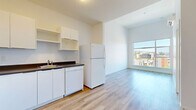 Located at 733 Goldstream Ave in Langford, BC, this one-bedroom, one-bathroom unit offers a well-organized and efficiently designed layout spread across a single floor. Light-toned hardwood flooring runs throughout the entire unit, lending a clean, cohesive look to every room.

The open living area is anchored by a large picture window that frames sweeping views of the surrounding Langford cityscape and treetops, filling the space with abundant natural light. The kitchen is thoughtfully laid out in an L-shape, featuring white cabinetry with ample storage, dark countertops, and white appliances including a stove, dishwasher, and refrigerator — offering full functionality in a compact footprint.

The bedroom is a bright, quiet retreat with its own large window that looks out to a balcony and open sky views of the neighbourhood. A dedicated closet adjacent to the bedroom provides practical storage solutions. The bathroom is clean and well-appointed, featuring a full bathtub with shower, a vanity with a dark countertop, and recessed lighting overhead. White walls and warm wood flooring keep the aesthetic light and fresh throughout. This unit is an ideal space for those seeking comfortable, modern living in the heart of Langford.