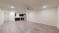 This single-story, 3-bedroom, 2-bathroom home offers a practical and modern layout designed for comfortable everyday living. The open-concept living room and kitchen area forms the heart of the home, featuring light gray wood-look flooring, recessed lighting, and a ceiling fan. The kitchen is equipped with rich dark espresso cabinetry, granite-style countertops, and a full suite of stainless steel appliances including a refrigerator, range, microwave, and dishwasher.

The three bedrooms are finished with plush carpeting and feature closets and window blinds, providing a quiet and comfortable retreat. The primary bedroom offers a generous footprint with ample closet space. The two bathrooms continue the dark cabinetry theme, paired with granite-style countertops and wood-look flooring for a cohesive aesthetic throughout.

A dedicated laundry room includes both washer and dryer hookups — washer connections and a dryer outlet — along with an overhead shelf for added storage. Neutral wall tones and clean white trim run throughout the home, creating a bright and move-in-ready atmosphere. The consistent design language across all rooms gives this home a polished, well-maintained character.