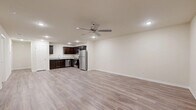 This single-story, 3-bedroom, 2-bathroom home offers a practical and modern layout designed for comfortable everyday living. The open-concept living room and kitchen area forms the heart of the home, featuring light gray wood-look flooring, recessed lighting, and a ceiling fan. The kitchen is equipped with rich dark espresso cabinetry, granite-style countertops, and a full suite of stainless steel appliances including a refrigerator, range, microwave, and dishwasher.

The three bedrooms are finished with plush carpeting and feature closets and window blinds, providing a quiet and comfortable retreat. The primary bedroom offers a generous footprint with ample closet space. The two bathrooms continue the dark cabinetry theme, paired with granite-style countertops and wood-look flooring for a cohesive aesthetic throughout.

A dedicated laundry room includes both washer and dryer hookups — washer connections and a dryer outlet — along with an overhead shelf for added storage. Neutral wall tones and clean white trim run throughout the home, creating a bright and move-in-ready atmosphere. The consistent design language across all rooms gives this home a polished, well-maintained character.