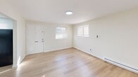 Located at 1127 Ward St in Chester, PA, this 2-bedroom, 1-bathroom unit offers a clean, modern living environment across a single floor. The interior is finished with light-toned hardwood flooring that runs consistently throughout, complementing the neutral, off-white walls to create a bright and cohesive aesthetic.

The living room serves as a welcoming entry point, featuring two windows with blinds that allow natural light to fill the space, along with a ceiling light fixture and baseboard heating. The kitchen is well-appointed with crisp white shaker-style cabinetry, brushed nickel hardware, a stainless steel sink with a modern faucet, a stainless steel range, and a full-size refrigerator — providing functional and attractive workspace.

Both bedrooms are comfortably sized with neutral walls, light hardwood floors, and baseboard heating. The primary bedroom includes a double sliding-door closet, while the second bedroom also features a built-in closet for ample storage. Each room benefits from natural light through windowed walls fitted with blinds.

The bathroom includes a clean white tub/shower enclosure with built-in shelving. Two hallways connect the rooms efficiently, contributing to a practical and well-organized floor plan. The overall ambiance is clean, updated, and move-in ready.