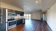 Located at 2645 Railroad Street in Pittsburgh's vibrant Strip District, this well-appointed 2-bedroom, 2-bathroom residence offers a thoughtfully designed open-concept layout. Rich hardwood-style flooring flows consistently throughout the entire unit, creating a cohesive and modern aesthetic.

The combined kitchen and living area serves as the heart of the home. The kitchen is outfitted with dark espresso cabinetry, granite-look countertops, and a full suite of stainless steel appliances including a refrigerator, electric range, microwave, and dishwasher. Recessed lighting brightens the space, while a sliding glass door leads to a private balcony, inviting natural light into the living area.

Both bedrooms are generously sized, featuring neutral walls and windows that offer outdoor views of the surrounding neighborhood. Three closets provide ample storage throughout the unit. The two bathrooms each include a tub-shower combination with a curved curtain rod, granite-look vanity tops, and dark cabinetry that mirrors the kitchen's design.

Additional conveniences include an in-unit laundry room, a utility room, and dedicated storage. The overall ambiance is clean, contemporary, and move-in ready, making this an ideal residence in one of Pittsburgh's most dynamic neighborhoods.
