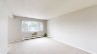 Located at 1345 N Western Ave in Saint Paul, MN, this 2-bedroom, 1-bathroom unit offers a practical and well-organized single-floor layout. The space is finished with a neutral, light color palette throughout, creating a clean and consistent look.

The spacious primary bedroom features soft wall-to-wall carpeting, a ceiling fan with light fixture, a baseboard heater, and a window that allows natural light to filter in. A set of full-length mirrored sliding closet doors adds both storage and a sense of openness to the room. The second bedroom is similarly carpeted and bright, also equipped with a ceiling fan and a mirrored sliding closet.

The kitchen area is finished with tile flooring and white cabinetry paired with dark countertops. A large window overlooks greenery outside, and a ceiling fan keeps the space comfortable. The kitchen flows naturally into the dining area, which benefits from the same tiled floor and natural light.

The bathroom is well-appointed with tile flooring, a white vanity with under-cabinet storage, a large mirror with overhead lighting, and a shower-tub combination with a white tile surround and curtain.

A dedicated closet provides additional storage. The overall layout is efficient and straightforward, making this unit a functional and comfortable home in Saint Paul.