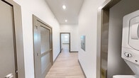 Located at 627 E Emma Ave in Springdale, Arkansas, this modern 2-bedroom, 3-bathroom single-floor unit offers a well-designed layout with clean finishes throughout. Light wood-style flooring runs continuously across all rooms, complemented by crisp white walls and gray trim accents that give the space a contemporary feel.

The open-concept kitchen and living area serves as the heart of the unit. The kitchen is well-appointed with gray shaker-style cabinetry, a white subway tile backsplash, stainless steel appliances including a refrigerator, microwave, and range, and a granite-topped island with a built-in sink. Industrial-style pendant lighting adds a stylish touch overhead.

Both bedrooms are bright and airy, each featuring ceiling fans and multiple windows that invite natural light and neighborhood views. The spacious primary bedroom includes a built-in vanity area and direct access to a private bathroom with granite countertops and a walk-in closet with built-in shelving.

The unit also includes a dedicated laundry room, a utility room with an accessible electrical panel, and two closets for additional storage. A welcoming entrance corridor with louvered doors leads efficiently into the living spaces, rounding out this thoughtfully designed and move-in ready home.