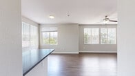 Located at 12845 Frederick St in Moreno Valley, CA, this 2-bedroom, 2-bathroom residence offers a thoughtfully designed single-floor layout. The open-concept kitchen and living area serves as the heart of the home, featuring wood-look laminate flooring, white shaker cabinetry, gray countertops, stainless steel appliances including a gas range and microwave, and a peninsula with bar seating — ideal for both cooking and casual dining. The adjacent living room is bright and airy, bathed in natural light from multiple large windows with views of the surrounding community, and equipped with a ceiling fan for year-round comfort. Both bedrooms are generously sized, finished with plush wall-to-wall carpeting, ceiling fans, and windows that bring in natural light. The primary bedroom offers comfortable proportions and convenient access to its own closet. Each of the two bathrooms is finished with wood-look flooring, a tub/shower combination with white tile surround, and clean, modern vanity fixtures. A dedicated entrance, hallway, and two closets round out the functional layout. The overall palette of soft neutral tones and clean white trim creates a cohesive, move-in-ready atmosphere throughout the residence.