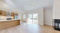 Located on Glendon Avenue in Los Angeles, CA, this well-appointed 2-bedroom, 1-bathroom unit offers a thoughtfully designed single-level layout with a clean, modern aesthetic throughout. Light-toned hardwood flooring flows seamlessly across all rooms, lending a bright and cohesive feel to the space.

The open-concept kitchen and living area serves as the heart of the home. The kitchen is outfitted with warm wood cabinetry, a glossy white tile backsplash, quartz countertops, a peninsula island, and stainless steel appliances including a gas range and full-size refrigerator. Soaring vaulted ceilings and a skylight above flood the kitchen with natural light. The living area features a striking corner fireplace with a sleek black surround and soaring walls that amplify the sense of openness. Sliding glass doors lead to a private balcony with views of swaying palm trees.

Both bedrooms are well-proportioned, bathed in natural light through sliding windows, and finished with the same light hardwood flooring. The primary bedroom offers generous space and recessed lighting. The bathroom is neatly appointed with a white vanity, quartz countertop, tile flooring, and a rounded mirror. A hallway connects all rooms efficiently, completing this clean and contemporary Los Angeles residence.