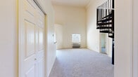 Located at 914 W Lake St in Fort Collins, Colorado, this two-story, 3-bedroom, 3-bathroom residence offers a thoughtfully designed layout spread across two levels. The main floor contains the majority of the living space, housing the kitchen, bedrooms, bathrooms, laundry room, and hallway, while an upper loft level provides additional flexible space accessible via a staircase framed by striking dark metal railings.

The kitchen is well-equipped with warm honey-toned cabinetry, dark granite-style countertops, hardwood-style flooring, and a full suite of black appliances including a range, microwave, refrigerator, and dishwasher. A tray ceiling with a pendant light fixture adds architectural interest where the kitchen opens toward the living area, which transitions to plush carpeting.

The bedrooms are carpeted and feature neutral warm tones, with windows that invite natural light and views of surrounding greenery. Several bedrooms include closets and individual climate control units. The bathrooms are finished with tile flooring, and the three full bathrooms provide ample convenience for all occupants.

A dedicated in-unit laundry room accommodates a stacked washer and dryer, adding practicality to daily living. The overall aesthetic throughout is clean, neutral, and functional, making this a well-rounded residence in the heart of Fort Collins.