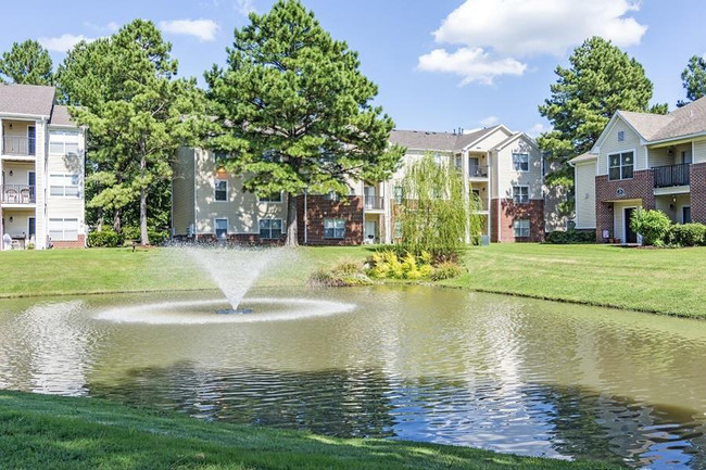 Community pond with a fountain in the middle - Arboretum Place Apartments