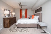 Located at 2059 Powers Ferry Rd SE in Marietta, Georgia, this single-floor residence offers a thoughtfully designed layout with a cohesive, contemporary aesthetic. The living area is generously proportioned, featuring rich hardwood-style flooring, crown molding, and built-in shelving flanking a central passage that connects to an additional sitting or flex space — ideal for a home office or secondary lounge. Natural light filters in through multiple windows, enhancing the open and airy feel throughout.

The dining area is anchored by a wood dining table beneath an elegant multi-light chandelier, with crown molding accents and drape-framed windows providing a refined atmosphere. Adjacent to the dining space, the kitchen is well-equipped with dark rich cabinetry, granite countertops, a white subway tile backsplash, and stainless steel appliances, offering both style and functionality.

The residence includes multiple bedrooms, each finished with plush carpeting and ceiling fans. The primary bedroom connects directly to an en-suite bathroom featuring granite vanity counters and dark wood cabinetry. Additional bedrooms are bright and comfortable, benefiting from natural light. Bathrooms throughout echo the same granite and dark cabinetry design language, ensuring a consistent and polished finish across the entire home.