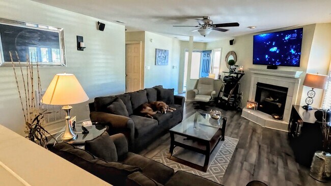 Large, open living room area with LVP and gas fireplace, wireless ceiling fan, in-wall surround soun - 424 Commerce Ave