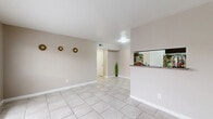 Located at 8515 Hammerly Blvd in Houston, Texas, this single-story, one-bedroom, one-bathroom unit offers a practical and well-organized layout. Light-toned large-format ceramic tile flooring runs consistently throughout the entire space, contributing to a clean, cohesive aesthetic.

The open living and dining area forms the heart of the unit, featuring neutral beige walls, white baseboards, and a flush-mount ceiling light. A pass-through kitchen counter with a granite-style surface and a stone-tile backsplash connects the kitchen to the living space, providing both functionality and visual interest.

The bedroom is a comfortable, well-proportioned room equipped with a ceiling fan with light kit and a window fitted with blinds that allows natural light to filter in. A dedicated walk-in closet with built-in shelving provides ample organized storage directly off the bedroom.

The bathroom is neatly appointed with a vanity featuring a granite-style countertop and dark cabinetry, a wall-mounted mirror, a toilet, and a shower-tub combination with a curtain. The tile flooring from the main living areas continues seamlessly into the bathroom.

A separate dining room and additional closet round out the layout, making efficient use of every square foot. The unit's consistent neutral palette and tile flooring throughout create a tidy, move-in-ready space in a convenient Houston location.