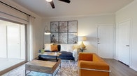 This single-story 1-bedroom, 1-bathroom residence delivers a cohesive blend of modern design and comfortable living across a well-utilized floor plan. The living room serves as the heart of the home, featuring crown molding, wood-look flooring, a ceiling fan, and a large sliding glass door that opens to a private patio with outdoor views — flooding the space with natural light. The kitchen is outfitted with dark espresso cabinetry, granite countertops, a subway tile backsplash, stainless steel appliances including a refrigerator, range, microwave, and dishwasher, plus pendant lighting and a breakfast bar. Wood-look flooring carries through to the kitchen and dining area, where there is ample room for a full dining set. The bedroom is carpeted and tranquil, featuring a window with blinds and sheer curtains that allow natural light while maintaining privacy. The bathroom mirrors the kitchen's design aesthetic with matching dark cabinetry, granite countertops, a full soaking tub and shower combination, and wood-look flooring. Throughout the residence, a neutral color palette and consistent finishes create a clean, cohesive, and inviting atmosphere.