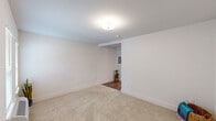 This single-floor studio in Metairie, Louisiana, offers a well-designed layout that maximizes functionality. The open living area features neutral-toned carpet, crisp white walls, and two windows fitted with blinds that allow natural light to fill the space. A wall-mounted HVAC unit provides convenient climate control.

The galley-style kitchen is thoughtfully appointed with rich dark-brown cabinetry, granite-style countertops, and a full suite of stainless steel appliances, including a refrigerator, dishwasher, microwave, and electric range. Wood-look plank flooring runs throughout the kitchen and hallway, complementing the cabinetry's warm tones.

A dedicated laundry area in the hallway houses a stacked washer and dryer unit, adding practical convenience. The bathroom features a granite-topped vanity with dark cabinetry, wood-look flooring, and an overhead storage cabinet, keeping the space both stylish and organized. The clean, neutral palette throughout creates a cohesive and move-in-ready environment well-suited for comfortable single-occupant living.