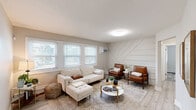Located at 3710 SE 14th St in Des Moines, Iowa, this thoughtfully designed one-bedroom, one-bathroom unit offers a comfortable and modern living experience across a single floor. Light wood-look flooring runs throughout, tying the space together cohesively.

The living room is a standout, showcasing a striking geometric shiplap accent wall that adds architectural character. Multiple windows invite abundant natural light, while the open layout provides ample room for both lounging and entertaining.

The kitchen features white shaker cabinetry, a classic subway tile backsplash, a stainless steel sink, and black appliances, creating a clean, contemporary aesthetic. A decorative round mirror adds a stylish finishing touch.

The bedroom is a calm retreat, equipped with a ceiling fan and a well-placed window that fills the room with natural light. The cozy scale of the room makes it feel intimate and restful.

A dedicated office space provides flexibility for remote work or study, complete with its own ceiling fan and window. The bathroom impresses with floor-to-ceiling marble-look tile in the tub/shower surround, accented by a mosaic tile inlay for an elevated, spa-like feel.

A connecting hallway ties all rooms together, completing this efficiently laid-out and attractively finished home.