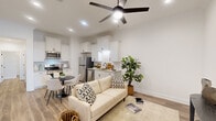 Located at 101 Barnes Ln in Broussard, Louisiana, this well-appointed 2-bedroom, 2-bathroom single-floor residence offers a thoughtfully designed layout with modern finishes throughout. The open-concept living and kitchen area serves as the heart of the home, featuring wood-look plank flooring, recessed lighting, and a sleek ceiling fan. The kitchen is outfitted with white shaker-style cabinetry, granite countertops, stainless steel appliances including a refrigerator, dishwasher, and range, a subway tile backsplash, and a matte black faucet — combining style with functionality. The living area provides a comfortable, bright space with room for dining as well. Both bedrooms are airy and well-lit, with large windows that invite natural light. The primary bedroom includes a closet and ample space for rest and relaxation. Each bathroom is finished with granite vanity countertops, white cabinetry, and wood-look flooring — one featuring a framed glass walk-in shower, the other a tub-shower combination. The hallways display decorative tile accents at the entryway. A dedicated laundry room with overhead cabinetry and a full-size washer and dryer completes this efficient, move-in-ready home.
