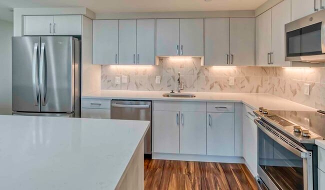 Premier homes feature modern kitchens with upgraded refrigerators, granite countertops and separate dining space - The Sterling Apartment Homes