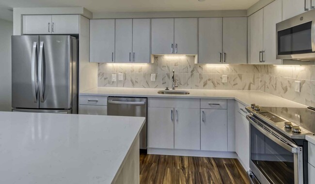 Premier homes feature modern kitchens with upgraded refrigerators, granite countertops and separate dining space - The Sterling