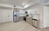 Located at 18412 Homestead Ave in Cutler Bay, FL, this thoughtfully designed 3-bedroom, 2-bathroom residence offers a clean, modern aesthetic throughout its single-floor layout. Light wood-look flooring flows seamlessly through the living areas and bedrooms, complemented by crisp white walls and abundant recessed lighting that create a bright, welcoming atmosphere.

The kitchen is a standout feature, showcasing two-tone cabinetry with white upper cabinets and warm wood-finish lower cabinets, white quartz countertops, a subway tile backsplash, and a full suite of stainless steel appliances including a French door refrigerator, range, microwave, and dishwasher.

The primary bedroom offers a comfortable footprint with direct access to a walk-in closet. The en-suite bathroom features a large vanity with white countertops, modern matte black hardware, a wide mirror with contemporary lighting, and a glass-enclosed shower. The second bathroom includes a tiled tub-shower combo, a matching vanity, and a tall linen cabinet for extra storage.

The additional bedrooms are bright and well-proportioned, each with closets and windows framing views of the surrounding Cutler Bay neighborhood with glimpses of palm trees. A connecting hallway ties all rooms together for a functional, efficient floor plan.