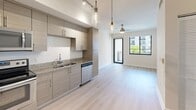 Located at 817 SE Second Ave in Fort Lauderdale, FL, this modern one-bedroom, one-bathroom unit offers a thoughtfully designed open-concept layout with clean, contemporary finishes throughout. Light wood-tone flooring flows seamlessly from the entrance through the kitchen and into the living area, creating a bright and cohesive feel.

The kitchen is well-appointed with flat-front cabinetry in a warm taupe wood finish, granite countertops, and a full suite of stainless steel appliances including a range, microwave, dishwasher, and refrigerator. Pendant lighting and a track light fixture add a modern touch overhead.

The open living area benefits from a large floor-to-ceiling window and sliding glass door leading to a private balcony, filling the space with natural light and providing outdoor views. A ceiling fan adds to the comfort of the room.

The bedroom is a comfortable, well-lit space with its own window offering exterior views, a ceiling fan, and direct access to a dedicated closet. The bathroom features a tub-shower combination with full tile surround, granite vanity countertop, and warm wood cabinetry. A dedicated entrance area completes the layout. This unit combines efficient use of space with modern design in a desirable Fort Lauderdale location.