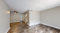 Located at 305 Glades Circle in Largo, Florida, this one-bedroom, one-bathroom residence offers a thoughtfully designed single-floor layout that maximizes functionality and comfort. The living room is a bright, open space featuring rustic wood-look flooring, neutral gray walls, a textured ceiling, and a ceiling fan, creating a welcoming and airy atmosphere. The galley-style kitchen is well-appointed with white shaker cabinetry, granite countertops, a subway tile backsplash, a stainless steel sink, and a full suite of stainless steel appliances including a refrigerator, range, and dishwasher. The wood-look flooring carries through the kitchen, adding a cohesive, modern feel. The bedroom is a comfortable retreat with plush carpeting, a natural light source from a window with blinds, and an expansive double sliding-door closet providing generous storage. The full bathroom features wood-look flooring, a clean white palette, a shower-tub combination, and a vanity with granite countertop detailing. Throughout the residence, consistent neutral tones and updated finishes create a clean, move-in-ready aesthetic suited for comfortable everyday living in the heart of Pinellas County.