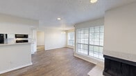 Located at 5409 Zion Rd in Garland, TX, this single-story 2-bedroom, 2-bathroom home offers a well-organized layout designed for comfortable everyday living. The open living and dining area serves as the heart of the home, featuring warm wood-look flooring, a textured ceiling, recessed lighting, and a chandelier accent. Large windows allow abundant natural light to fill the space, while a tiled fireplace adds a classic, cozy focal point. The kitchen is efficiently designed with white cabinetry, laminate countertops, a stainless steel sink, and stainless steel appliances, including a full-size refrigerator, all set on matching wood-look flooring. Both bedrooms are carpeted for comfort and include ceiling fans with lighting. The primary bedroom offers a dedicated closet and natural light from a window overlooking the outdoors. The second bedroom is equally comfortable with its own closet. The two bathrooms feature wood-look flooring, with one including a tub/shower combination with a clean white surround. A connecting hallway ties all rooms together, providing a functional flow throughout the home. With two dedicated closets and a practical layout, this home delivers solid functionality in a straightforward, well-maintained package.